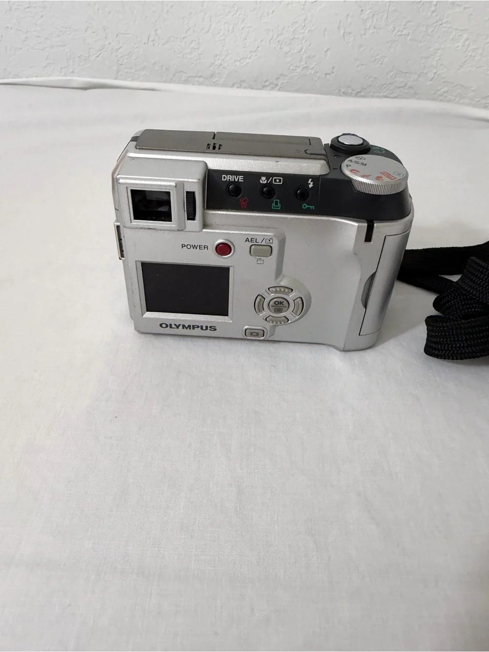 Olympus Silver Compact Digital Camera with Black Wrist Strap